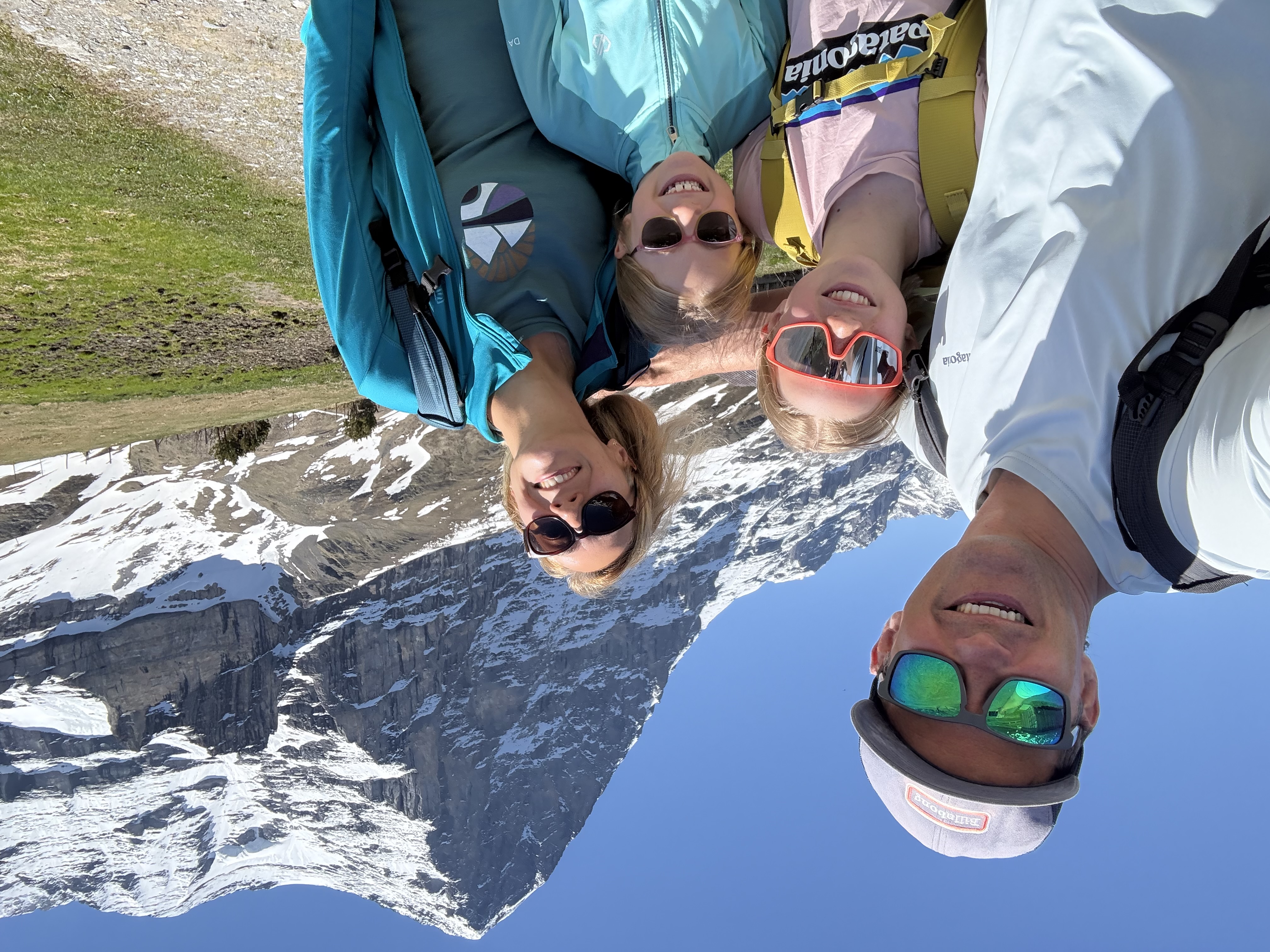 Family hiking together in the Swiss Alps